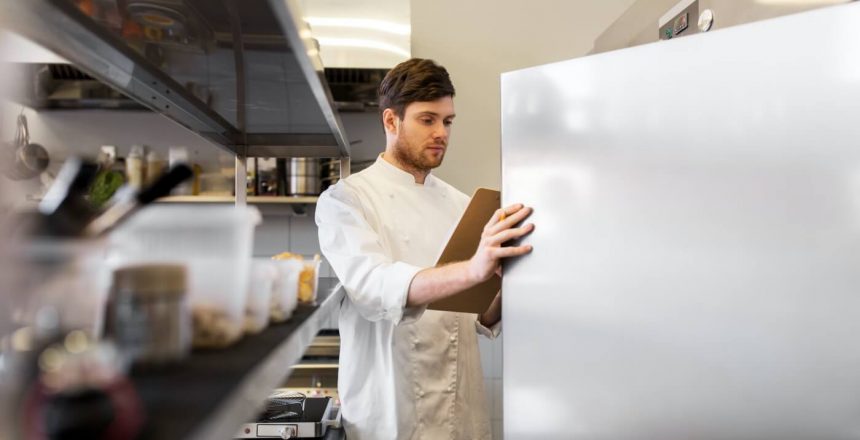 chef with clipboard doing inventory at kitchen chef with clipboard doing inventory at kitchen