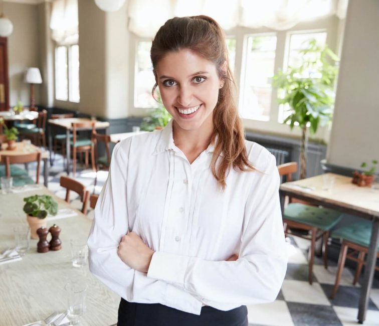 Portrait Of Female Restaurant Manager In Empty Dining Room Portrait Of Female Restaurant Manager In Empty Dining Room