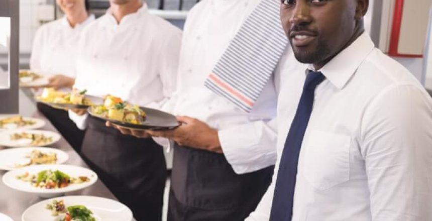 Restaurant manager with his kitchen staff Restaurant manager with his kitchen staff