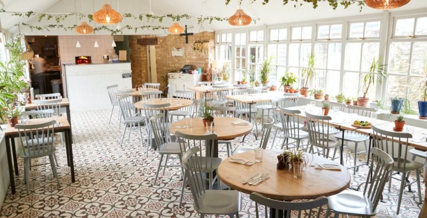 Tables and chairs in an empty restaurant in bright daylight Tables and chairs in an empty restaurant in bright daylight