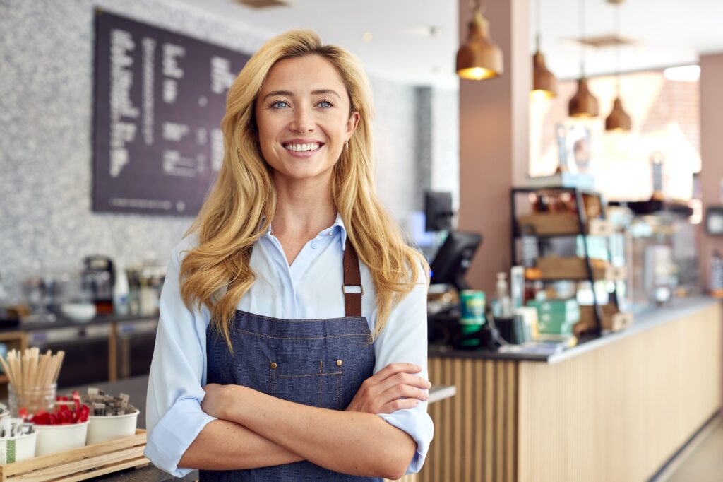 Portrait Of Female Owner Or Worker In Coffee Shop Or Restaurant