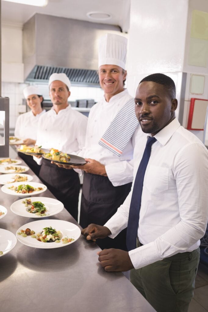 Restaurant manager with his kitchen staff